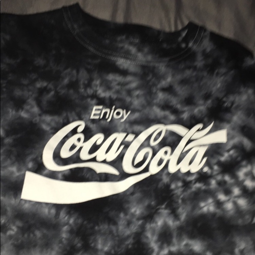 a faded off black and white coca cola shirt